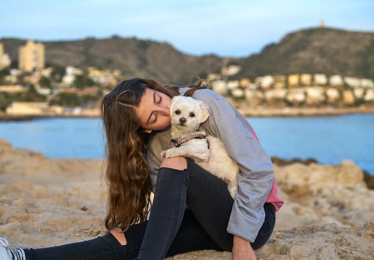 Girl Kissing Her Maltichon (Bichon Frise Maltese Mix) by The Lake| DogTemperament.com