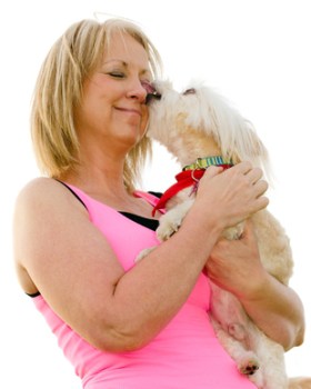 Woman with Maltipoo licking her face
