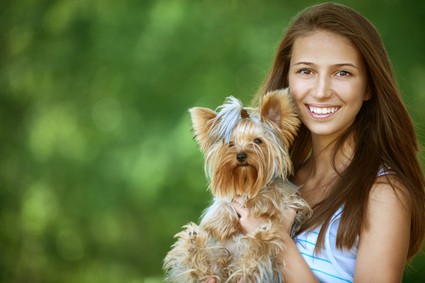 miling woman with Yorkshire Terrier