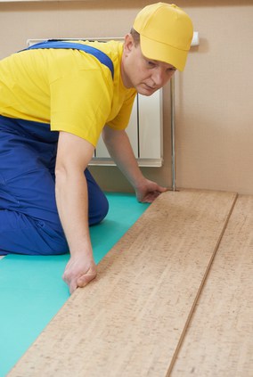 worker laying flooring
