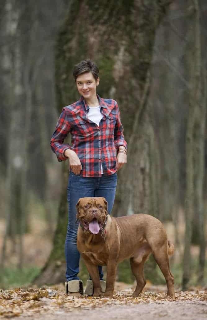 Photo of Woman and her Dogue De Bordeaux in the Woods
