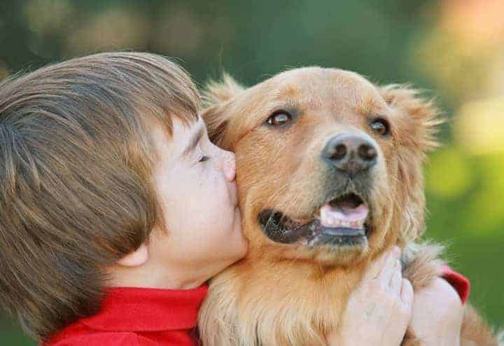 Photo of Little Boy Kisses Dog
