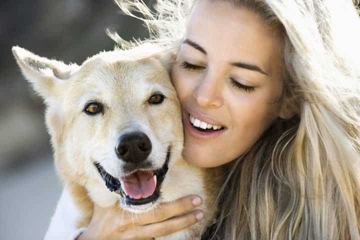 Photo of Pretty Woman Hugging Dog