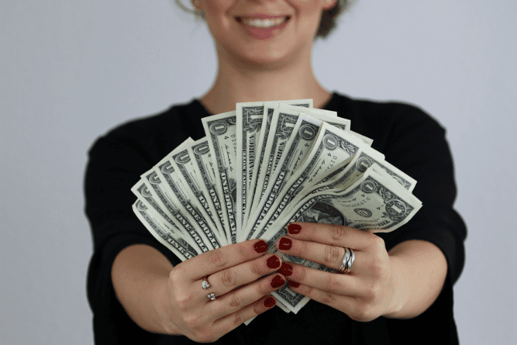 Photo of A Woman Holding Dollars